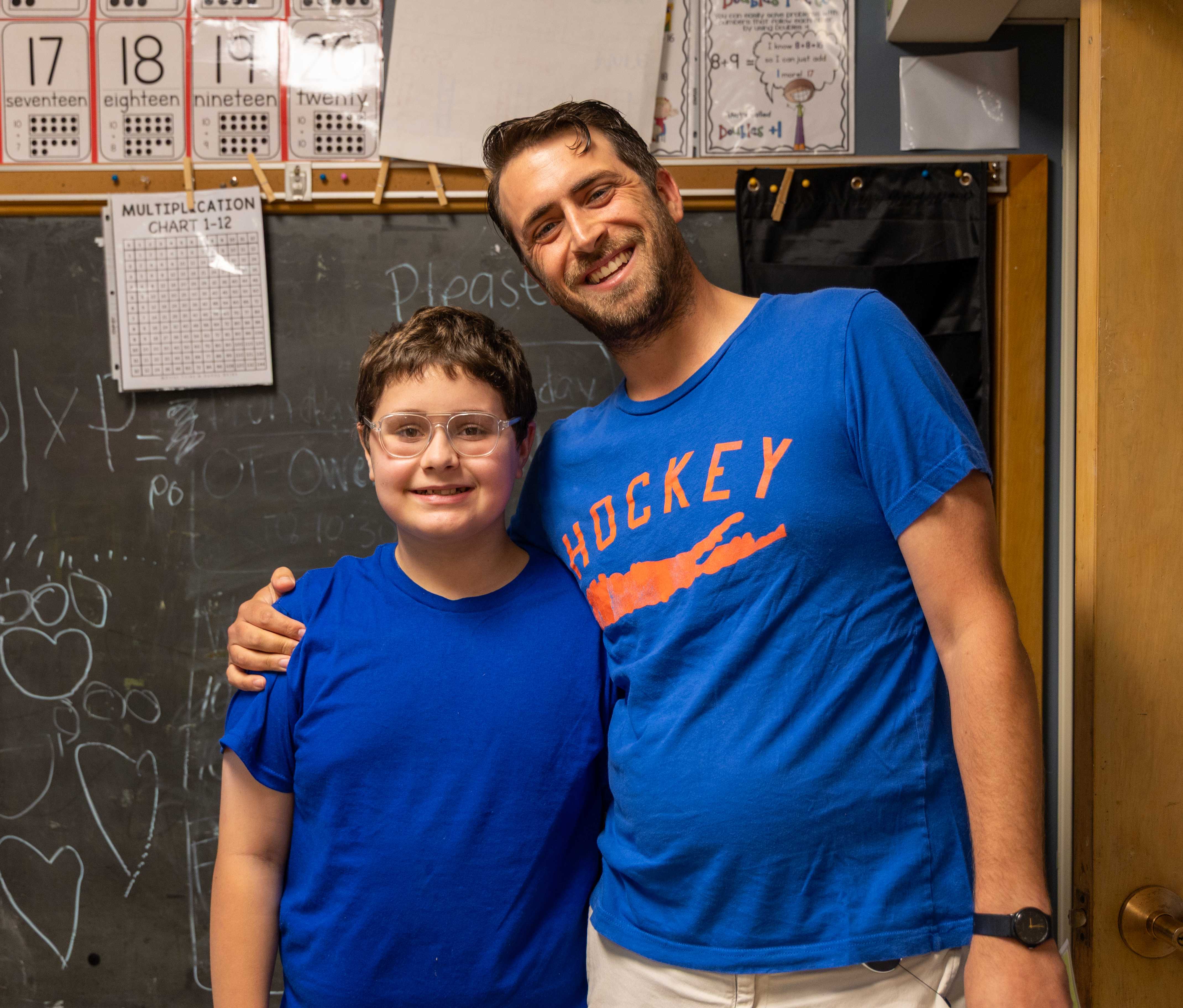 school guidance counselor, Mr. T hugs and smiles with a student